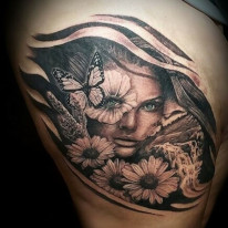 Ray Durham tattoo of a woman's face amid a landscape of flowers and river with butterflies. Tattoo created in black and grey with minor color detail.